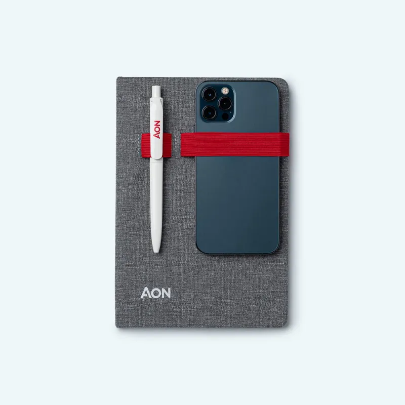 AON notebook with pen and phone lifestyle shot