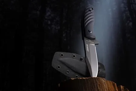 Hunting knife in woods lifestyle product shot